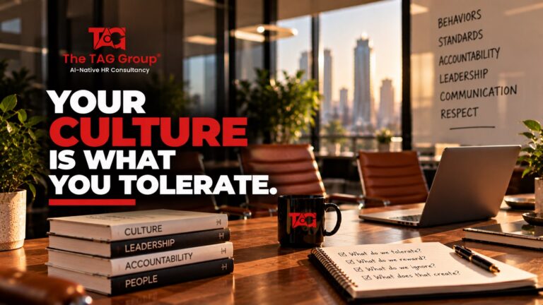 A boardroom with a wall listing behaviours, standards, accountability, leadership, communication and respect, and a notebook asking what do we tolerate, headlined 'Your culture is what you tolerate.'